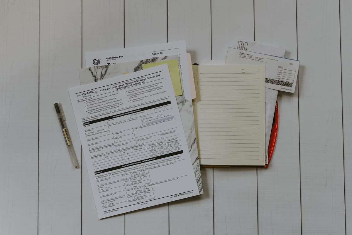 Stack of papers and documents arranged in a flat lay, representing a review or audit process